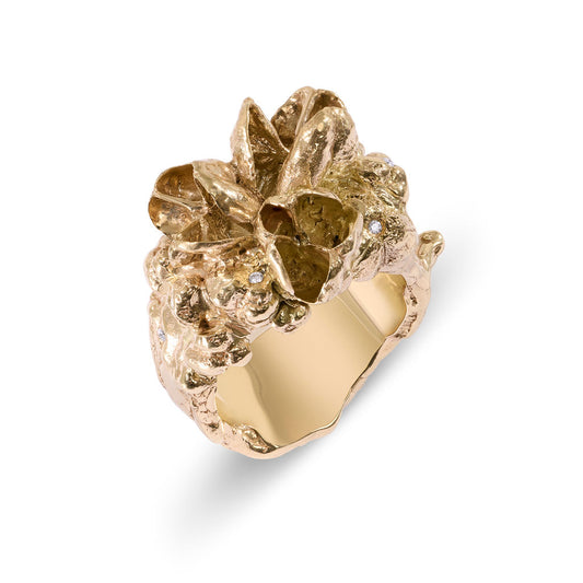 Gold ring with floral design on a white background