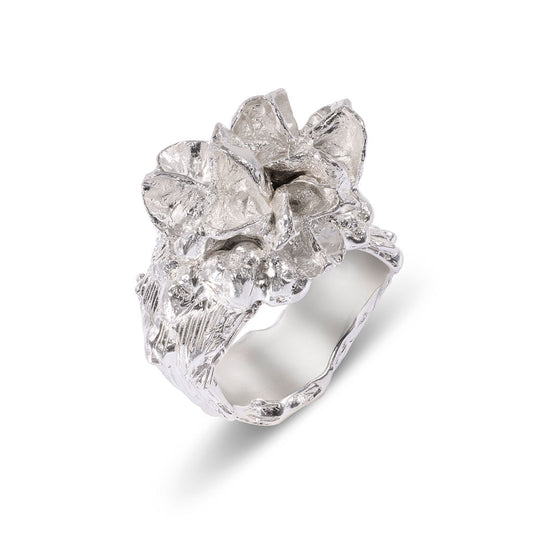 Silver sculptural ring with a textured band on a white background