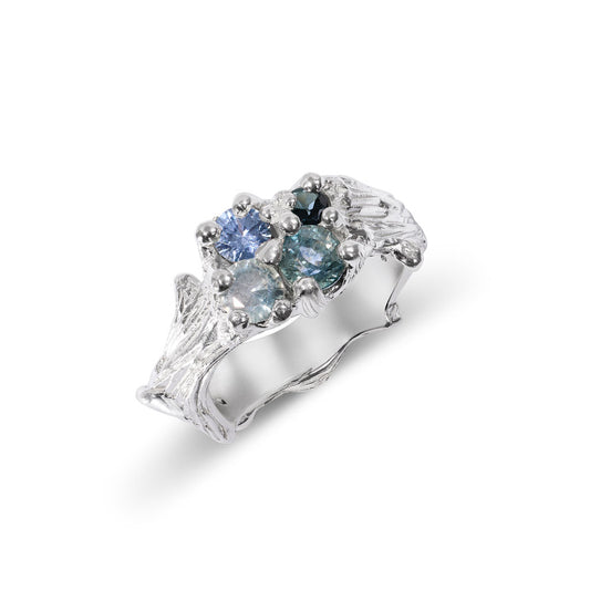 Silver ring with blue gemstones on a white background