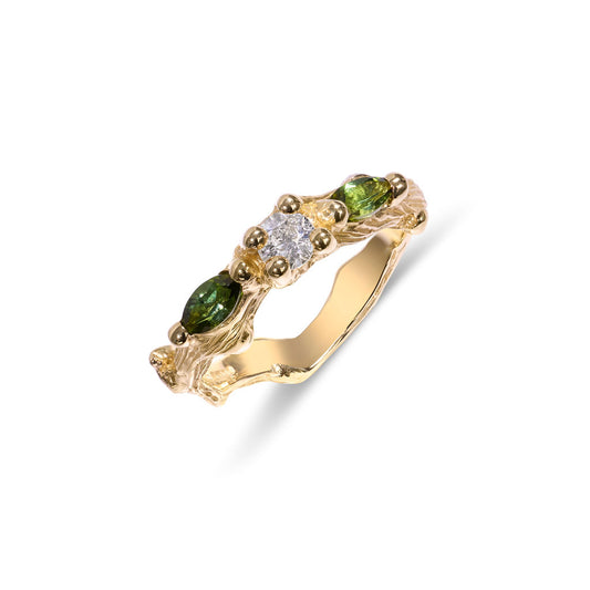 Gold ring with green gemstones and a diamond on a white background