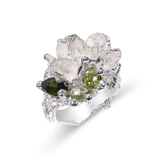 Silver ring with green gemstones on a white background