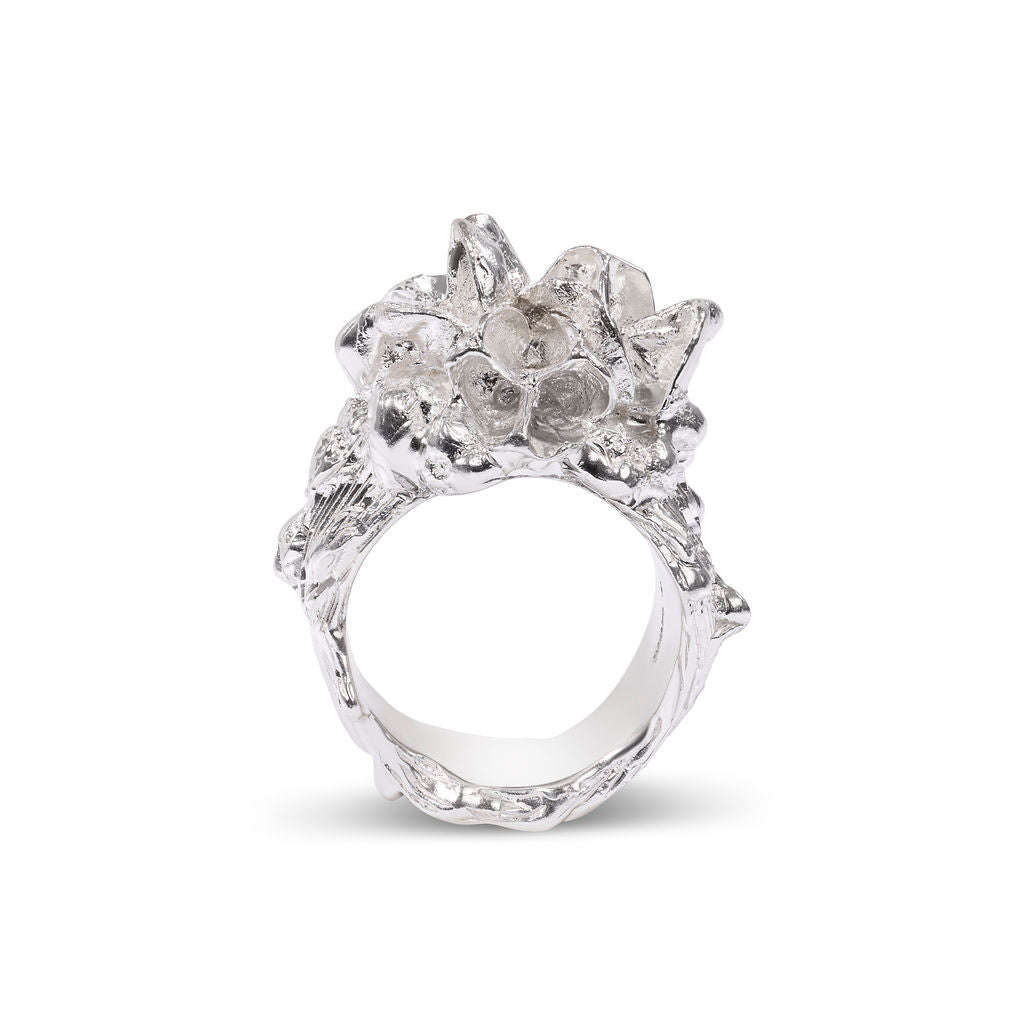Silver ring with floral design on a white background